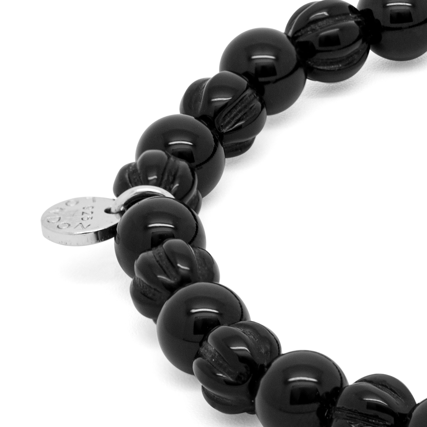 A rhodium-plated silver bracelet with black agate beads and silver discs.
