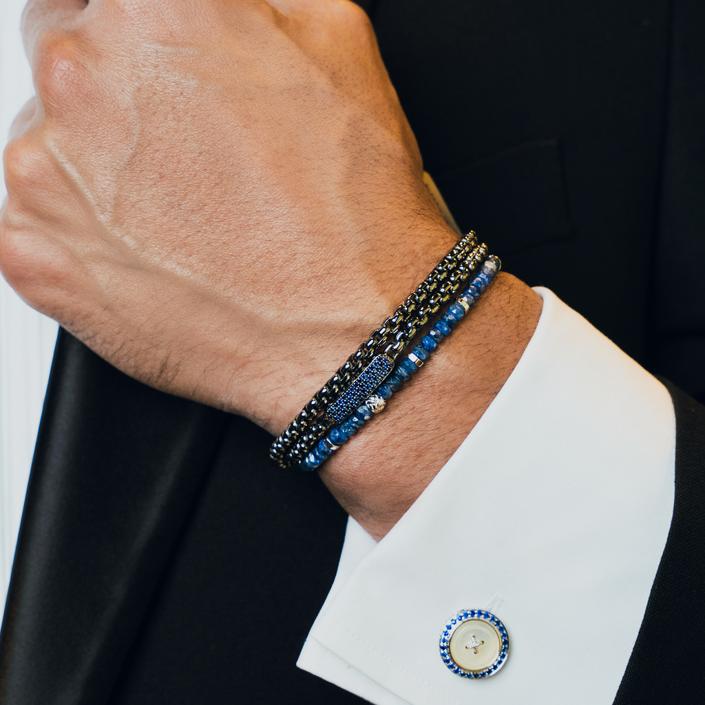 A rhodium-plated silver bracelet with blue sapphire beads and a lobster clasp.