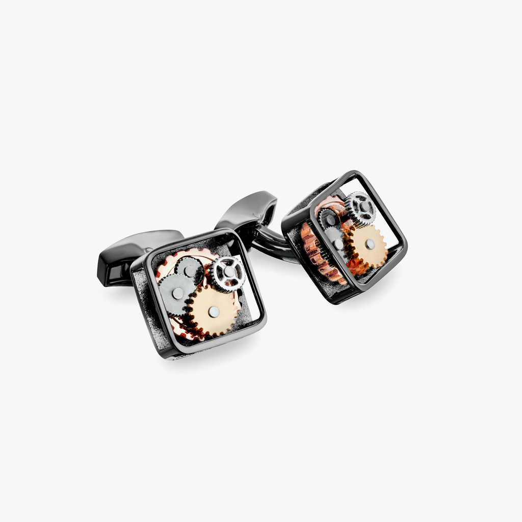 A pair of black gunmetal plated square gear cufflinks with visible mechanical gears inside the links.