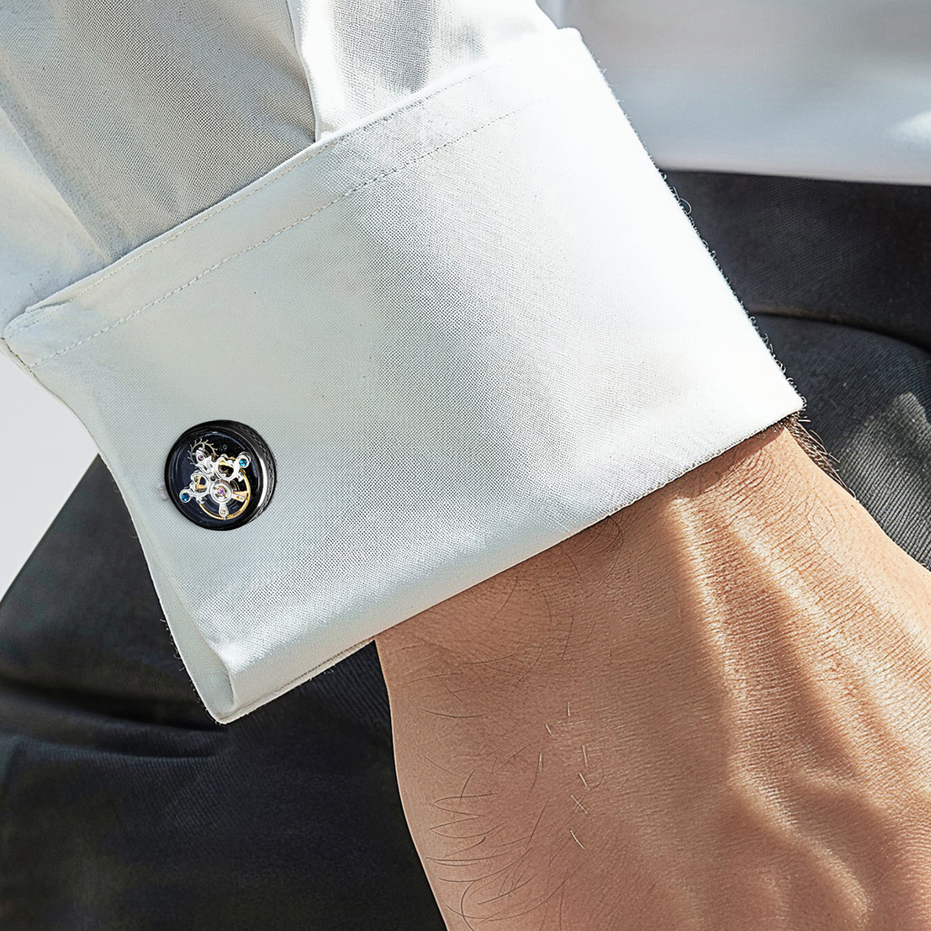 A pair of gunmetal cufflinks with black enamel and tourbillon gear detail.
