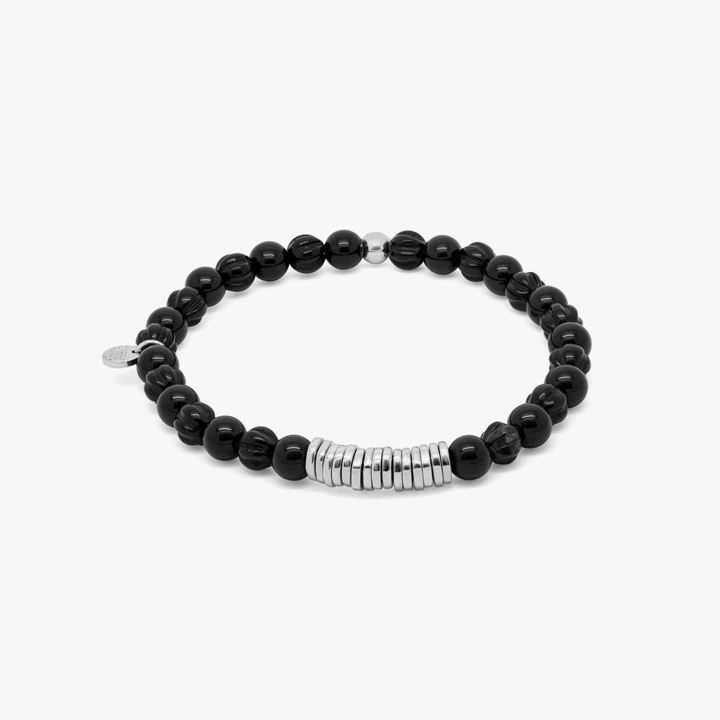 A rhodium-plated silver bracelet with black agate beads and silver discs.
