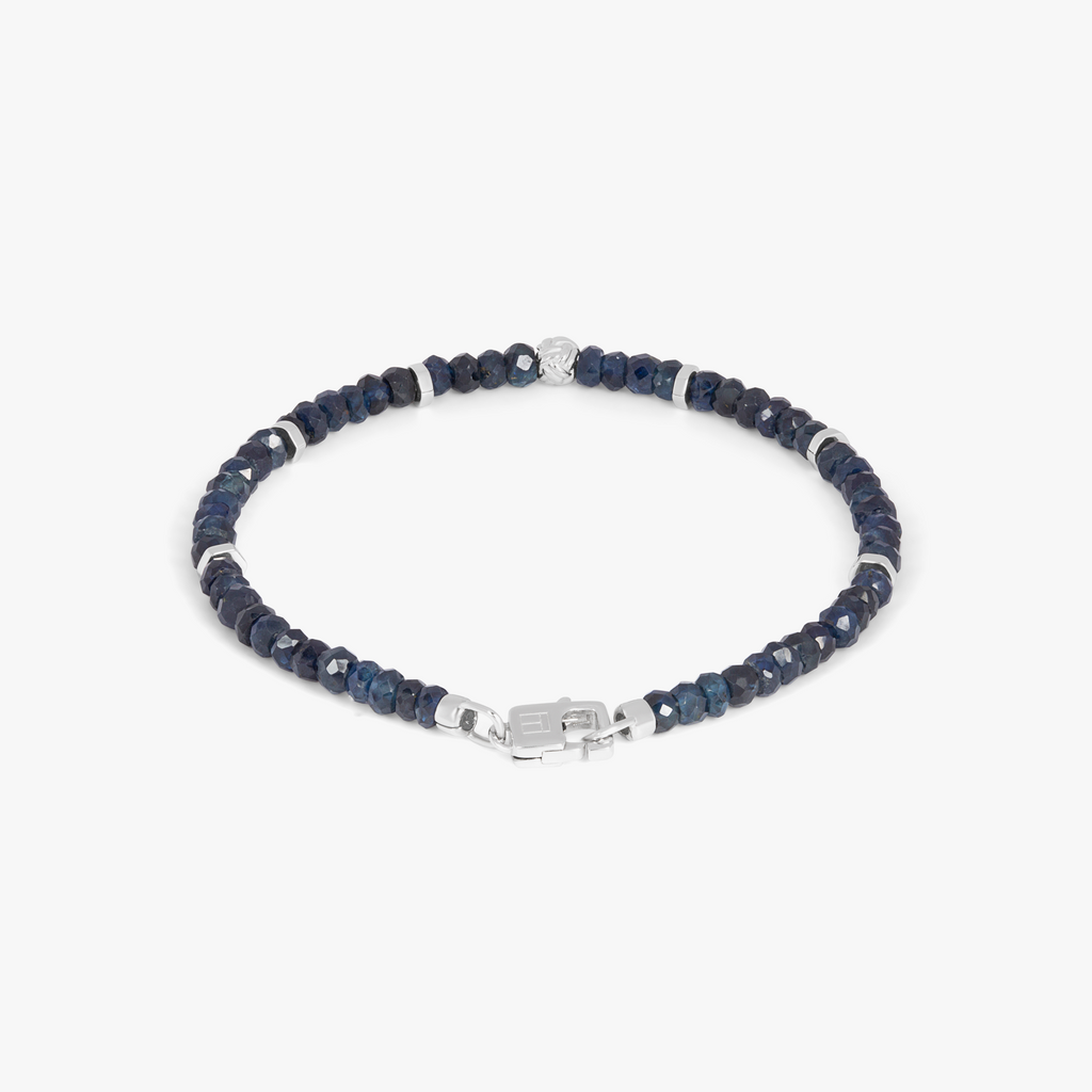 A rhodium-plated silver bracelet with blue sapphire beads and a lobster clasp.