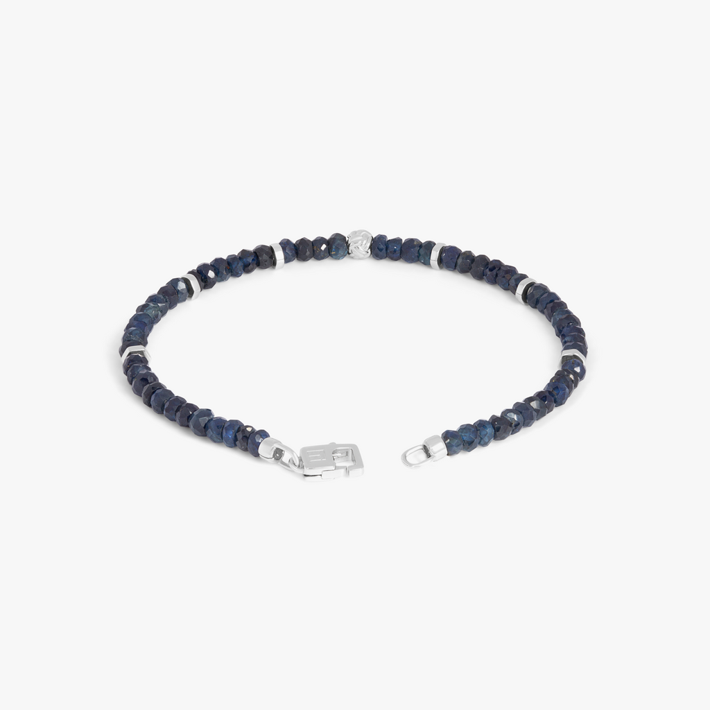 A rhodium-plated silver bracelet with blue sapphire beads and a lobster clasp.