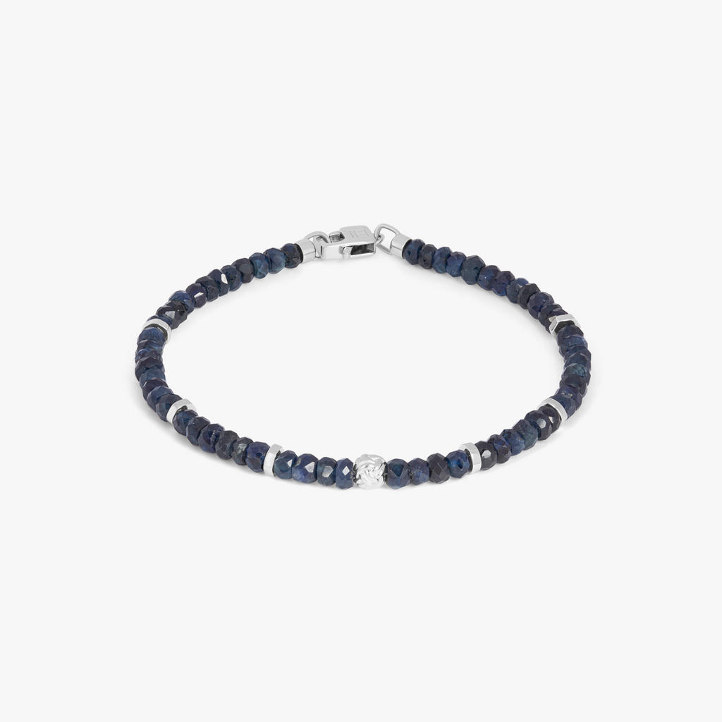 A rhodium-plated silver bracelet with blue sapphire beads and a lobster clasp.