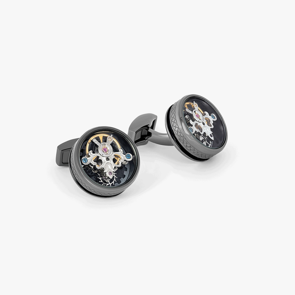 A pair of gunmetal cufflinks with black enamel and tourbillon gear detail.