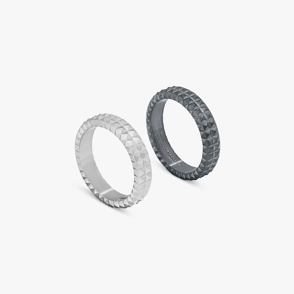Two rings stacked in a 'Doppio' style with a gunmetal black finish and diamond pattern detailing.
