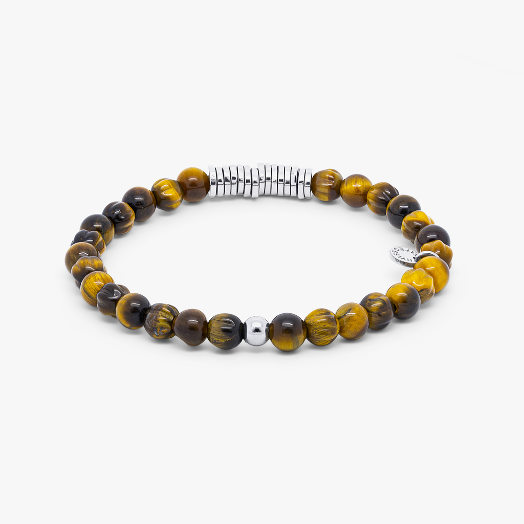 A rhodium-plated silver bracelet with brown tiger eye beads, featuring a closed elastic band and hand-carved semi-precious stones.