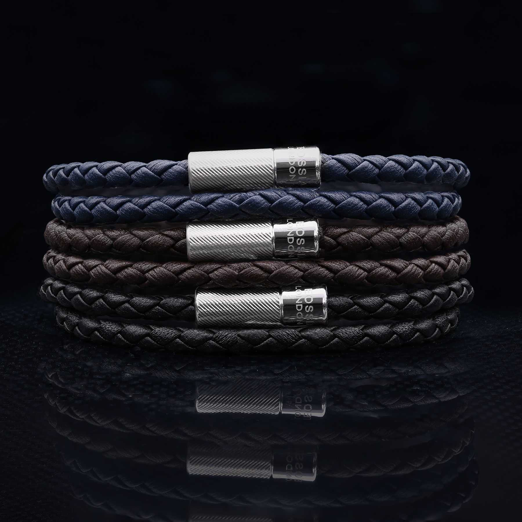 A double wrap brown leather bracelet with an engraved sterling silver clasp.