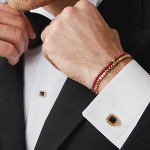 Man wearing Nodo bracelet with ruby and sterling silver