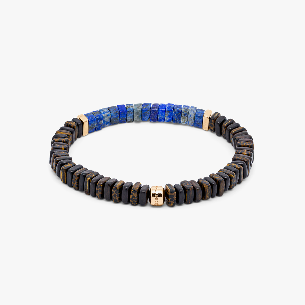 A bracelet with a combination of dark and light wood beads, accented by rose gold-colored sterling silver discs and a central lapis stone.