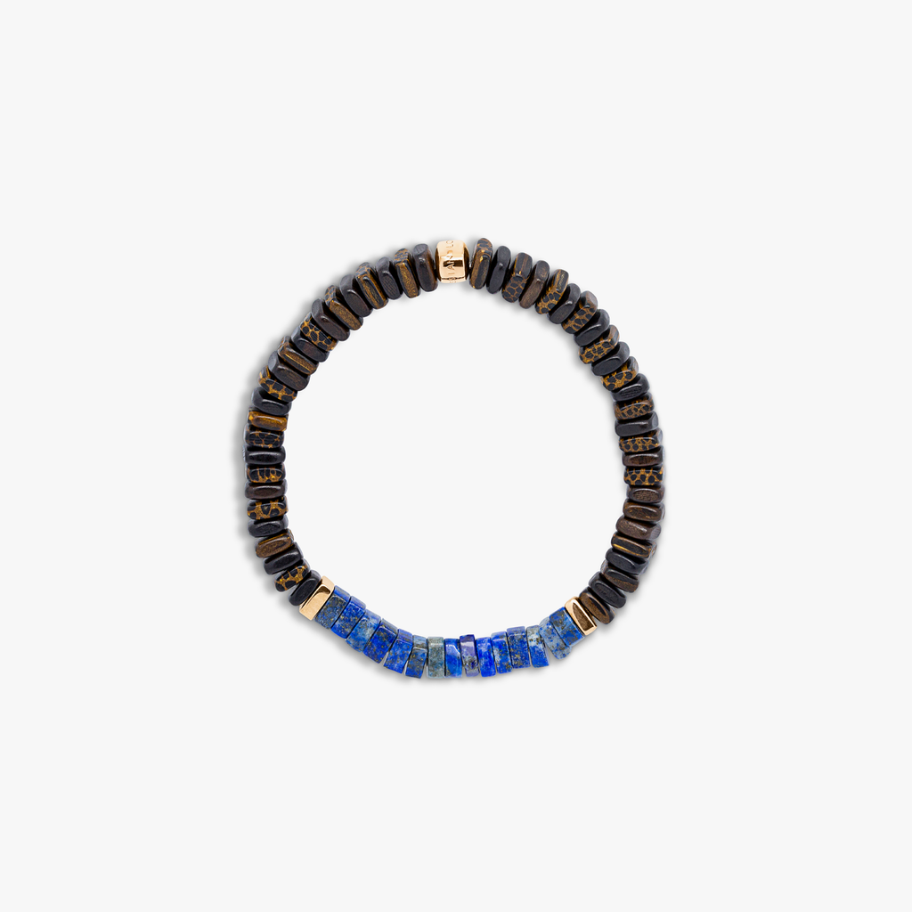 A bracelet with a combination of dark and light wood beads, accented by rose gold-colored sterling silver discs and a central lapis stone.