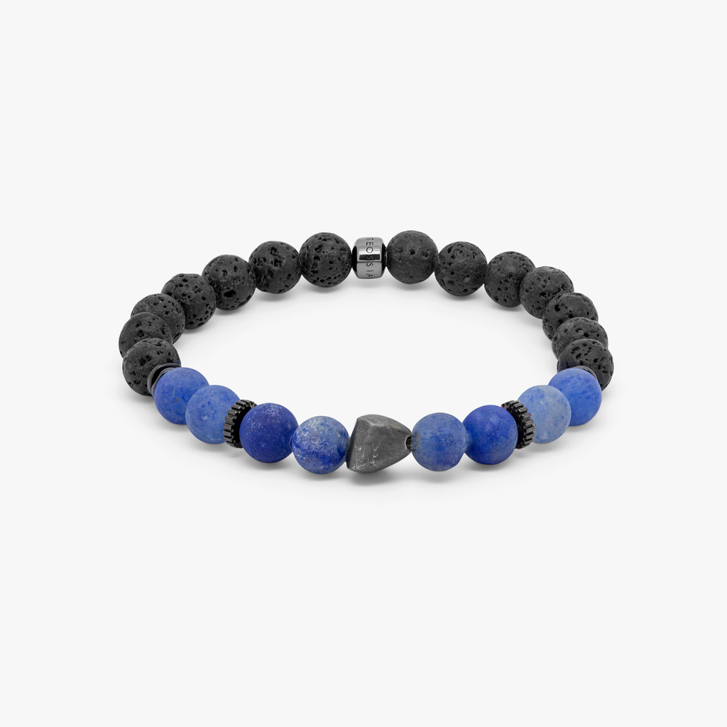 A bracelet with a mix of dark and light blue beads, some shaped like lava rocks, and black rhodium plated sterling silver detailing.
