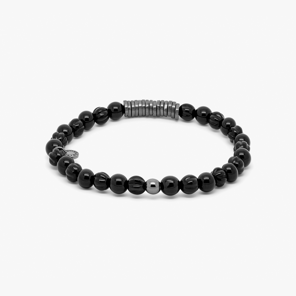 A black beaded bracelet with black ruthenium plated sterling silver discs.