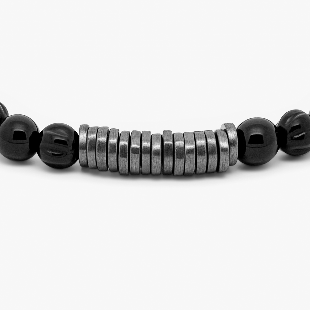 A black beaded bracelet with black ruthenium plated sterling silver discs.