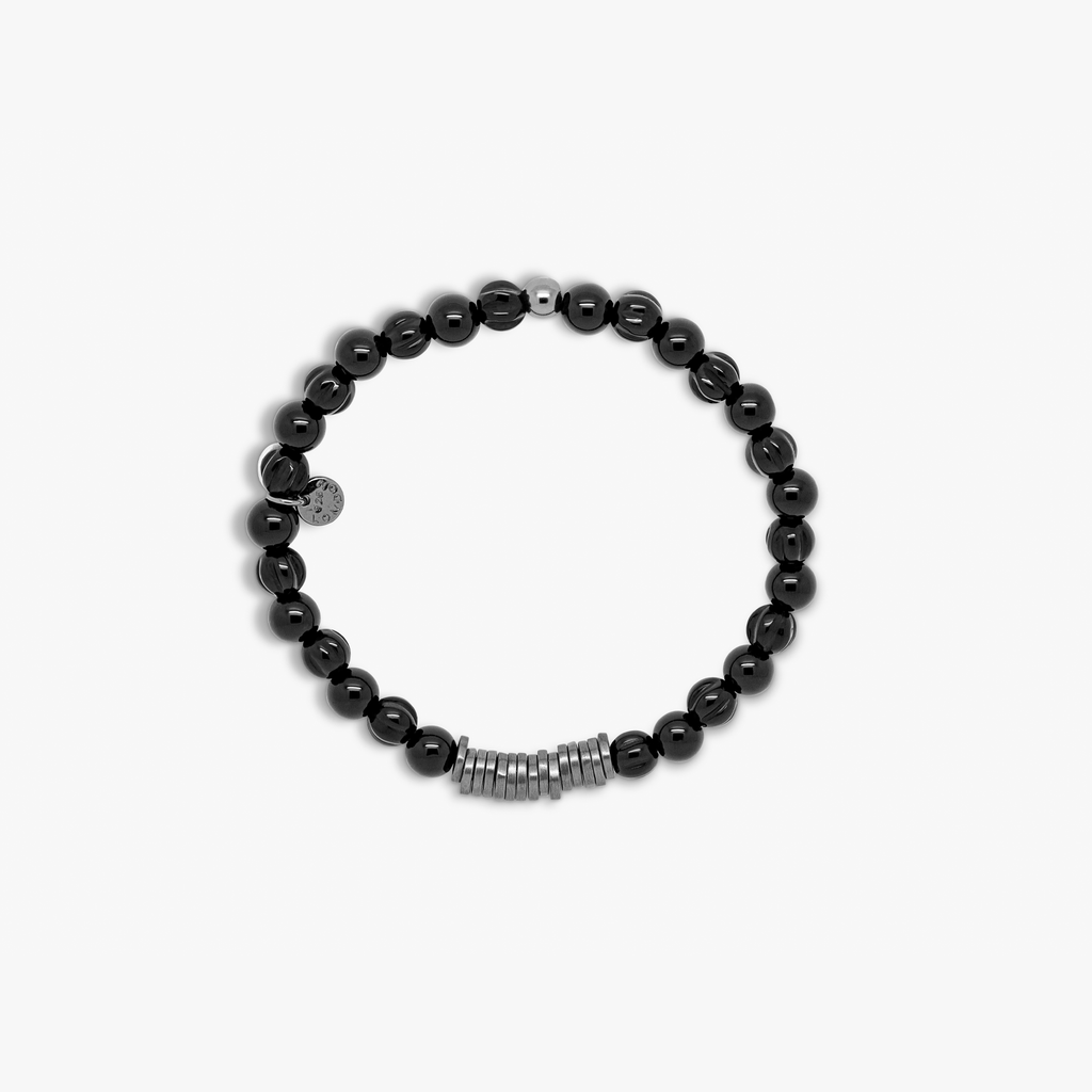 A black beaded bracelet with black ruthenium plated sterling silver discs.