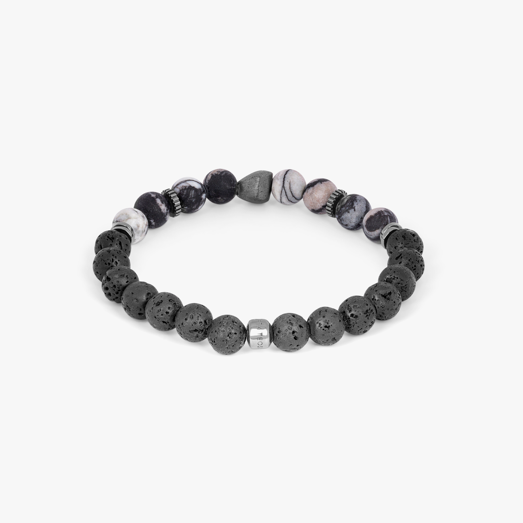 A bracelet with a combination of black and multicolored beads, possibly spiderweb jasper and raw volcanic lava beads, with black rhodium plated sterling silver detailing.
