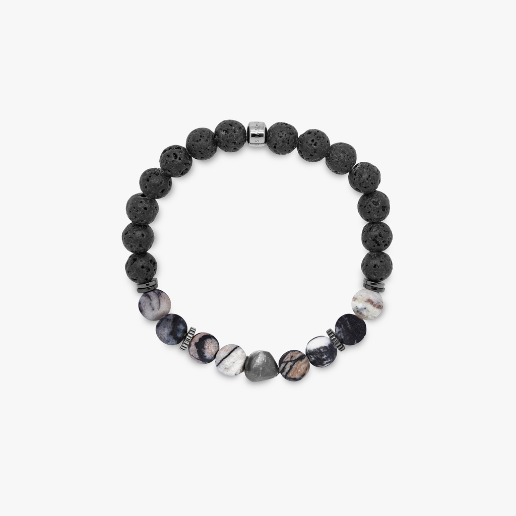 A bracelet with a combination of black and multicolored beads, possibly spiderweb jasper and raw volcanic lava beads, with black rhodium plated sterling silver detailing.