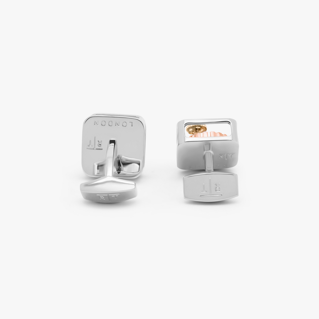 A pair of silver square gear cufflinks with palladium plating and visible mechanical gears inside.