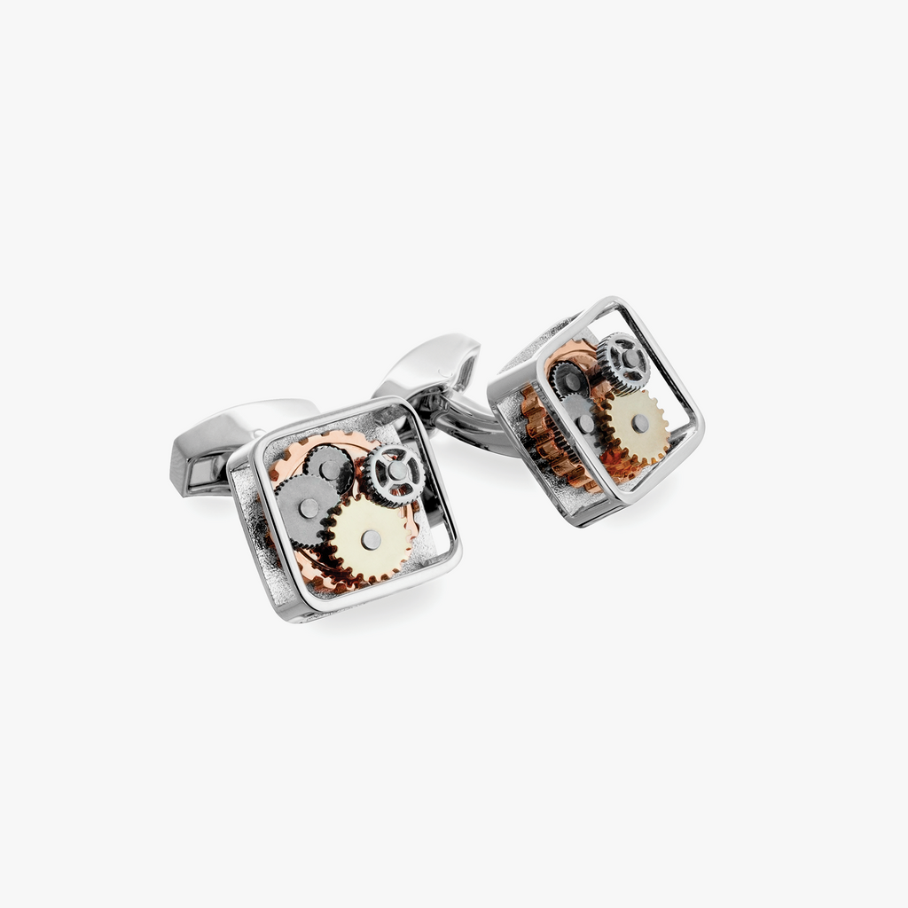 A pair of silver square gear cufflinks with palladium plating and visible mechanical gears inside.