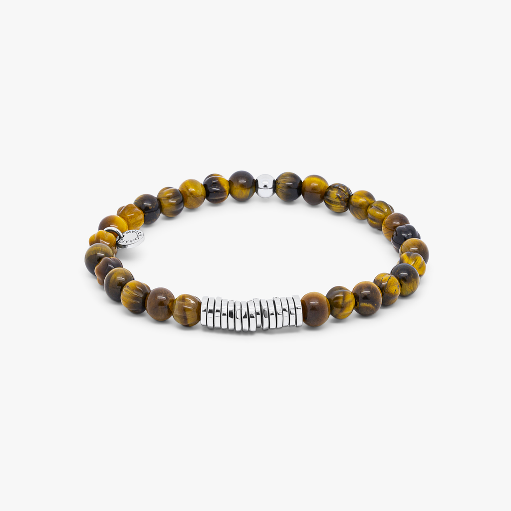 A rhodium-plated silver bracelet with brown tiger eye beads, featuring a closed elastic band and hand-carved semi-precious stones.