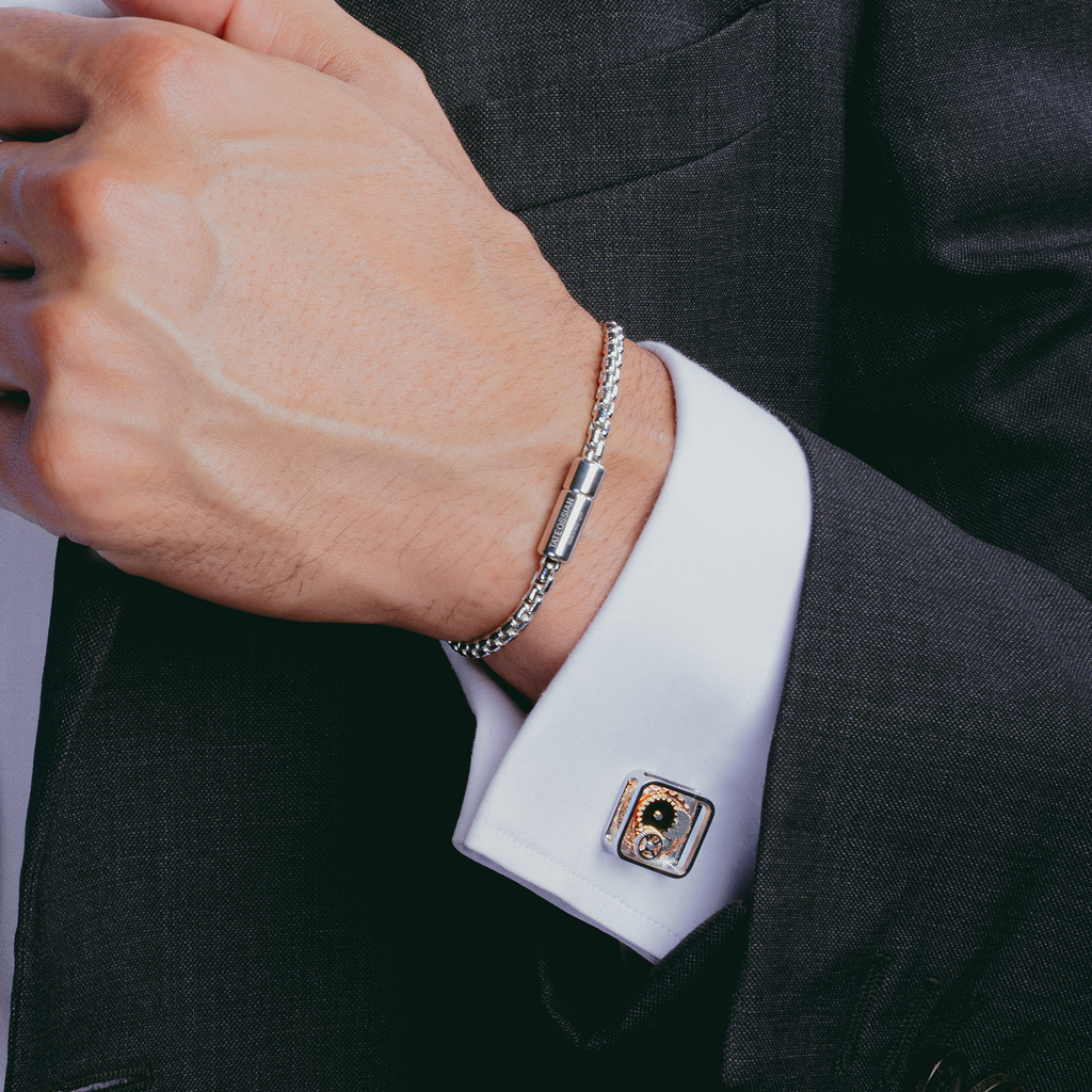 A pair of silver square gear cufflinks with palladium plating and visible mechanical gears inside.