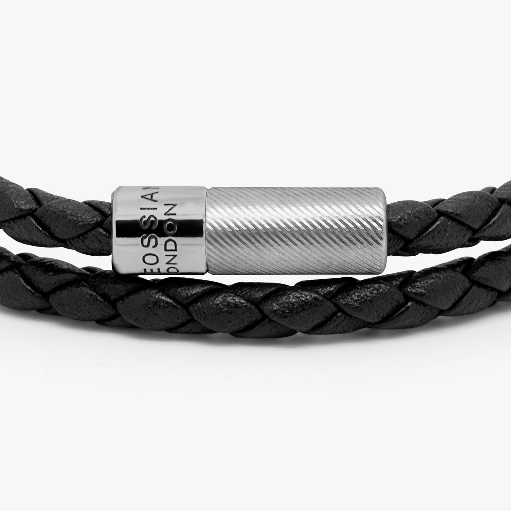 A black leather bracelet with a sterling silver clasp, double wrapped and intricately braided