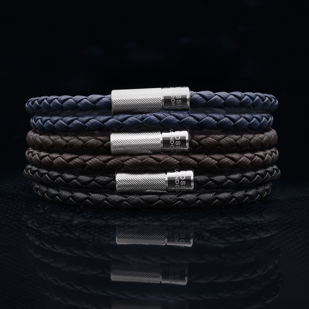 A black leather bracelet with a sterling silver clasp, double wrapped and intricately braided