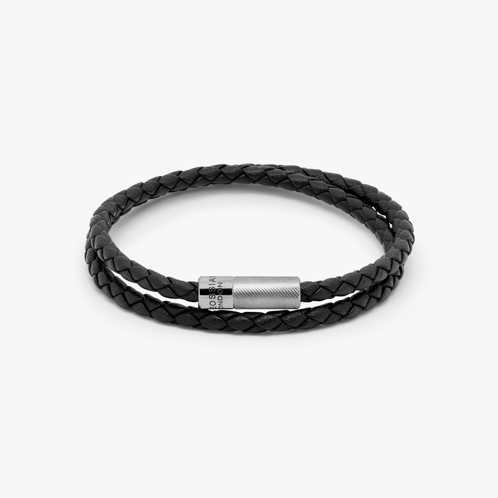 A black leather bracelet with a sterling silver clasp, double wrapped and intricately braided