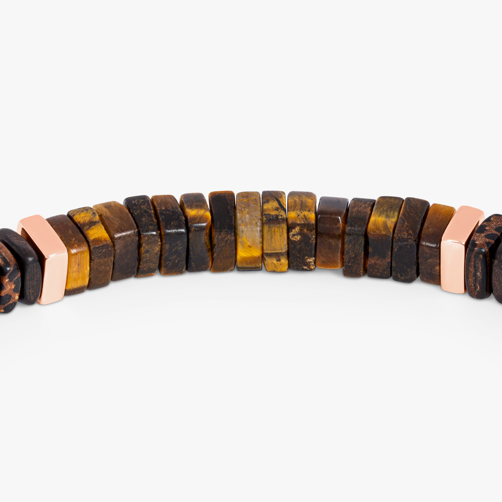 A bracelet made of tiger eye, palm and ebony wood with rose gold plated sterling silver accents.