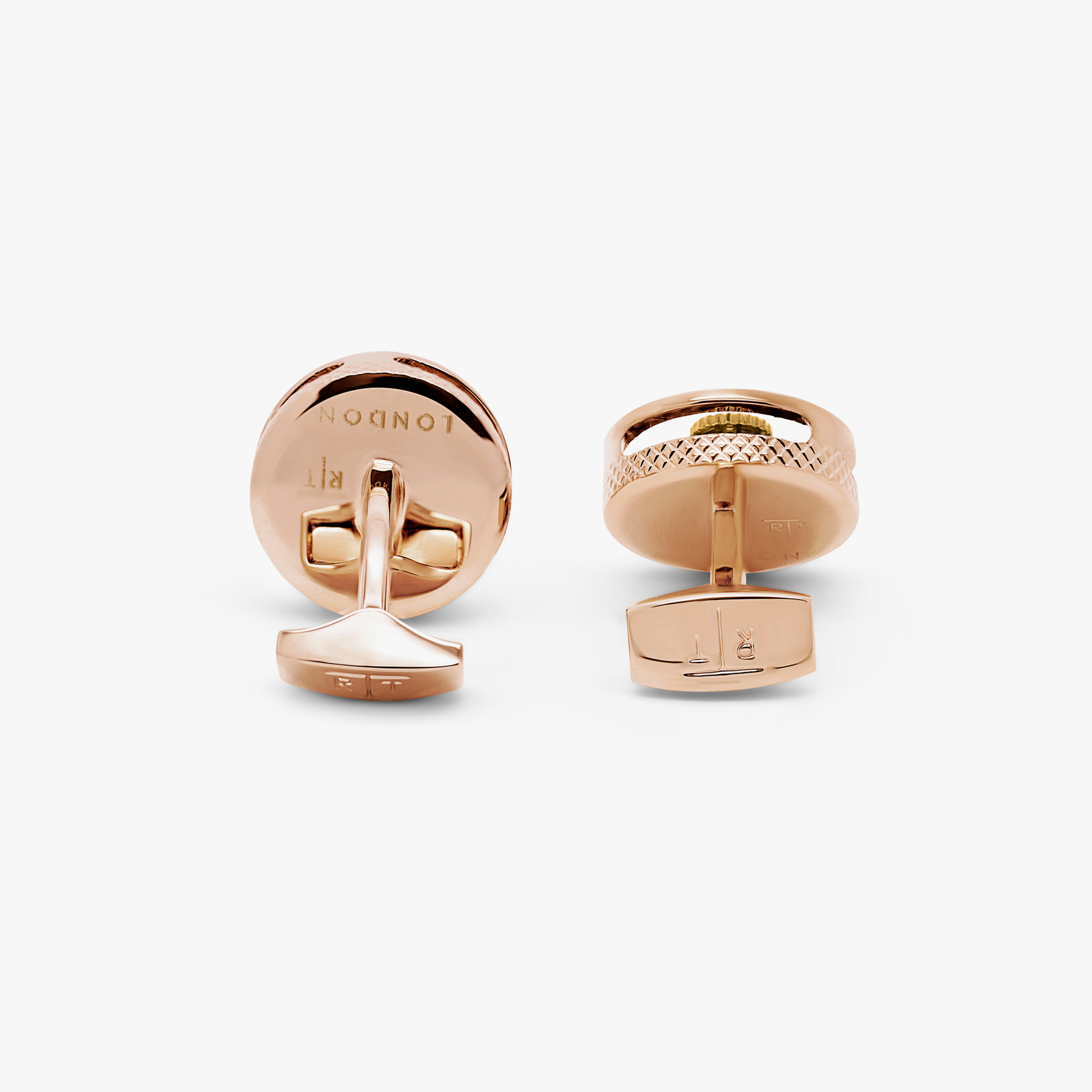 A pair of round gear cufflinks with a rose gold finish and visible mechanical gears inside.